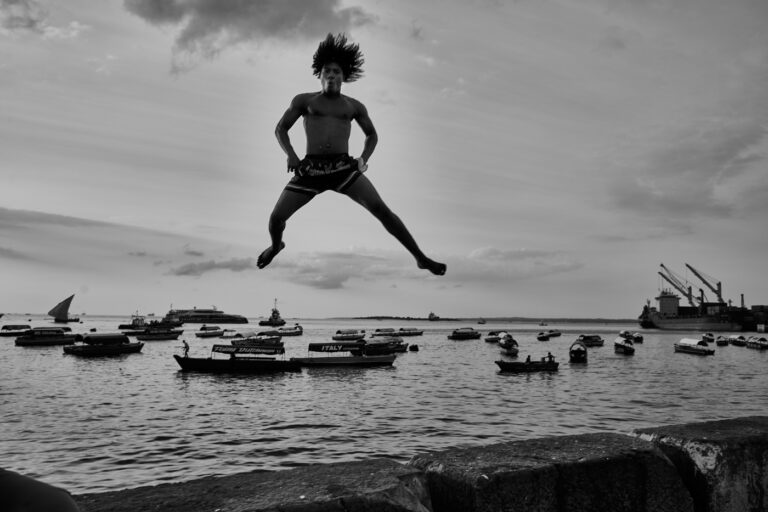 Saut face à la baie de Stonetown à Zanzibar